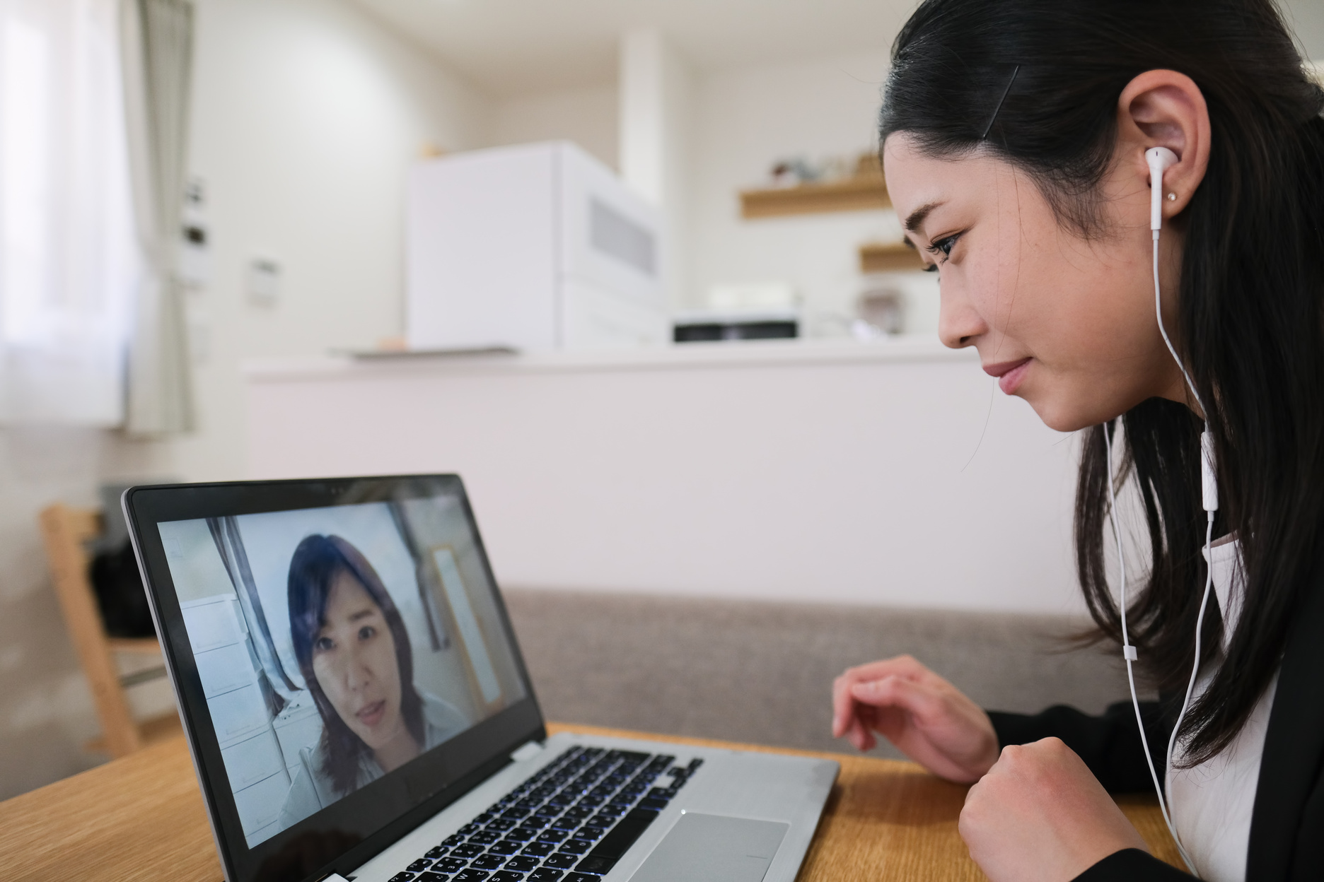 Two businesswomen talking on web conferences